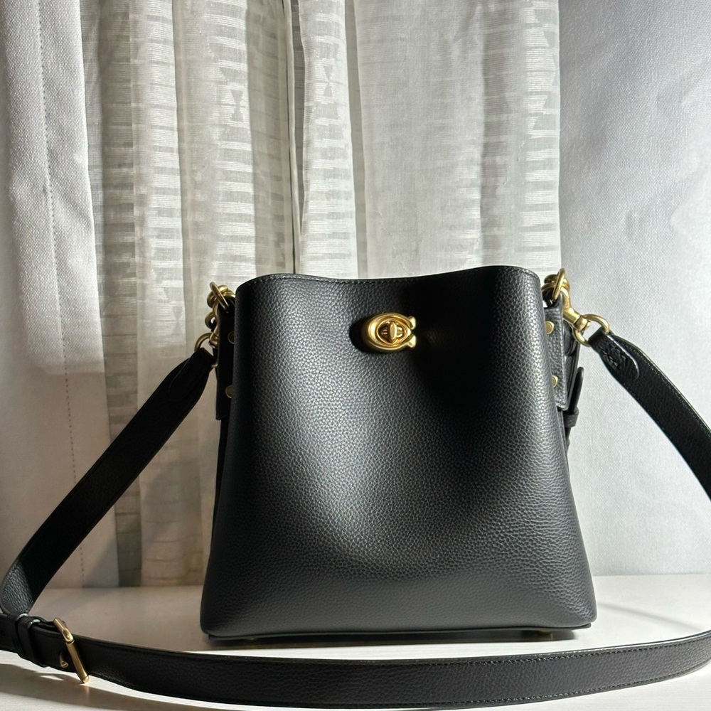 Used like NEW Coach Willow Bucket Bag in BLACK WITH GOLD accents w/dust bag.